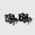 Pair of black metal bear traps on a light gray background