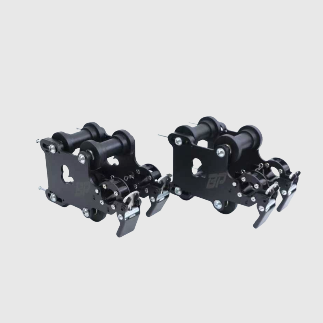 Pair of black metal bear traps on a light gray background